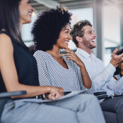 audience-listening-to-presentation-and-smiling