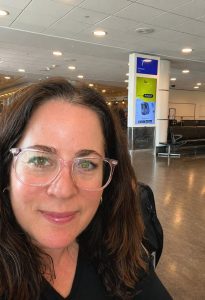 Photo of Suzannah Baum in an airport waiting area